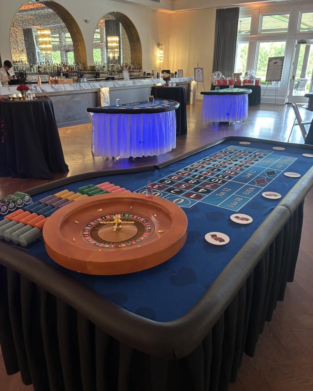 Roulette table with chips and uplit gaming tables at a country club